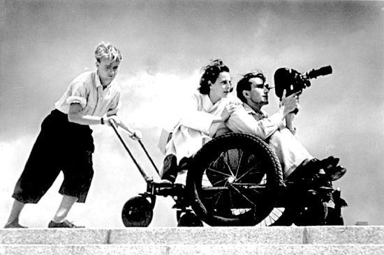 Leni Riefenstahl, center, filming with two assistants, 1936.