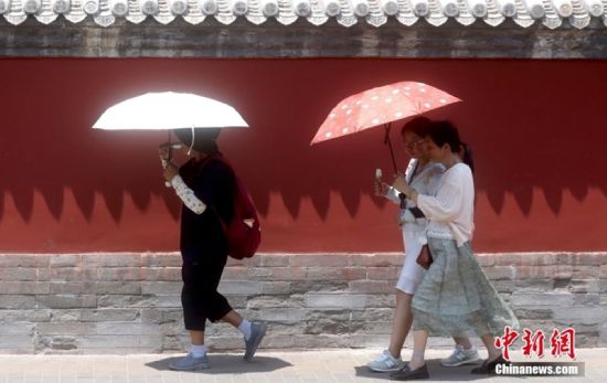Pedestrians holding umbrellas