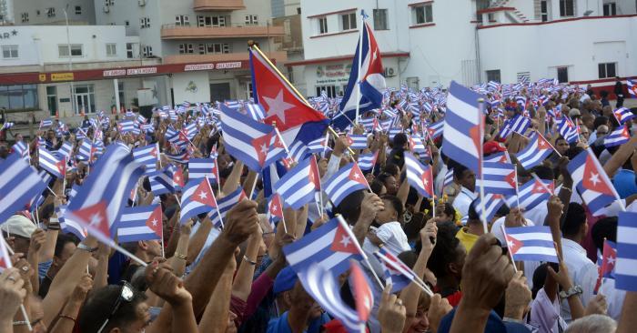 Crowd waving small Cuban flags