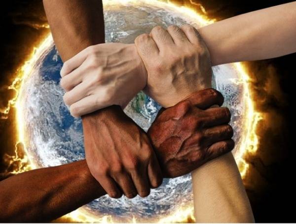Hands together over burning Earth