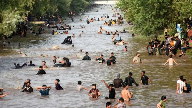 People cool off themselves during a heat wave in a canal in Lahore, Pakistan on June 20, 2025. Temperature reached over 40 degrees Celsius in many cities of Pakistan