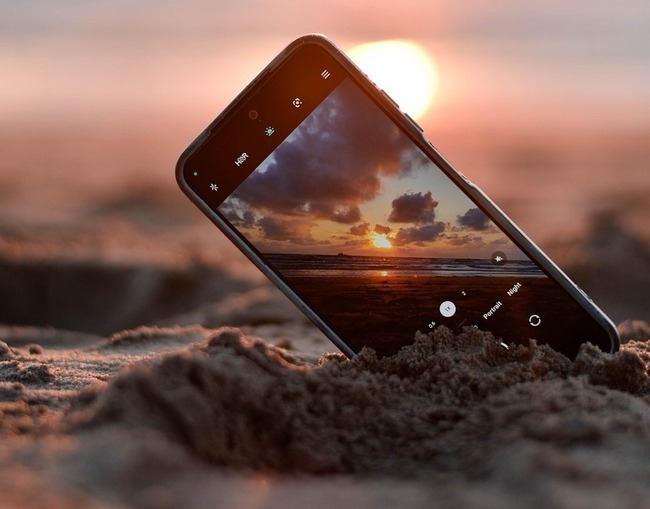phone in ocean, sunset