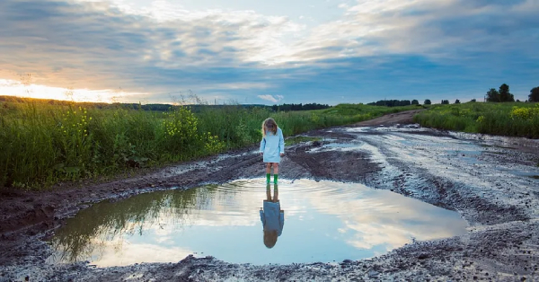 reflection of sky in a water puddle