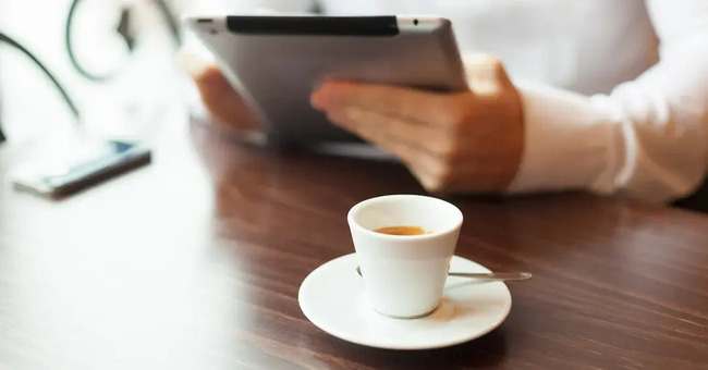 woman reading tablet, with coffee
